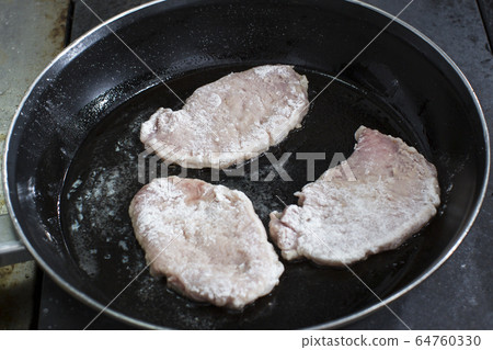 Cooking chops in a pan shot close-up. Cooking chops in a pan shot close-up. 64760330