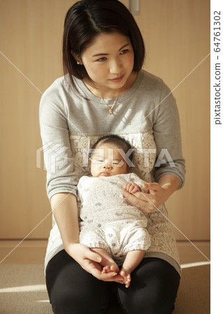 A mother holding a newborn baby A mother holding a newborn baby 64761302