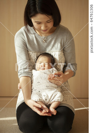 A mother holding a newborn baby A mother holding a newborn baby 64761306