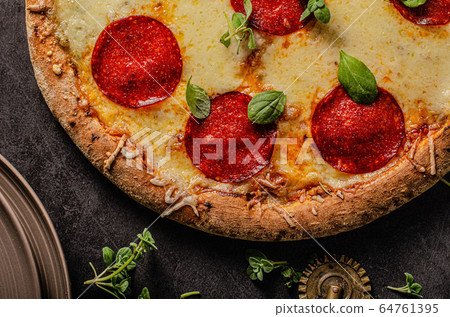 Homemade salami pizza with cheese corners Homemade salami pizza with cheese corners 64761395