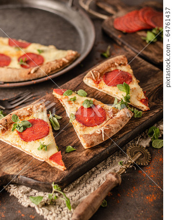 Homemade salami pizza with cheese corners Homemade salami pizza with cheese corners 64761437