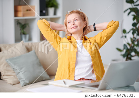 Relaxed blond businesswoman in casualwear enjoying short break on couch Relaxed blond businesswoman in casualwear enjoying short break on couch 64763323