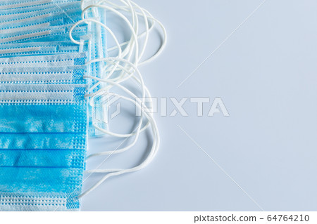 Medical masks on a light background. 64764210