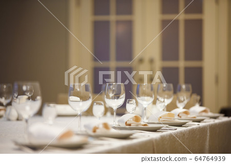 Row of place settings on table for a wedding reception Row of place settings on table for a wedding reception 64764939