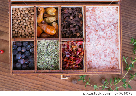 Wooden box with a collection of spices 64766073