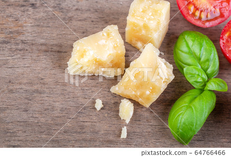 Pieces of Parmesan Reggiano and basil 64766466