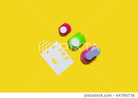 row of hole punchers near a paper 64766736