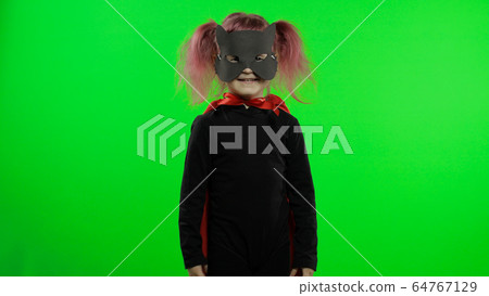 Funny child girl in costume and mask plays super hero. National superhero day 64767129