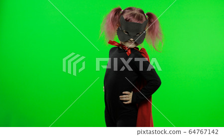 Funny child girl in costume and mask plays super hero. National superhero day 64767142