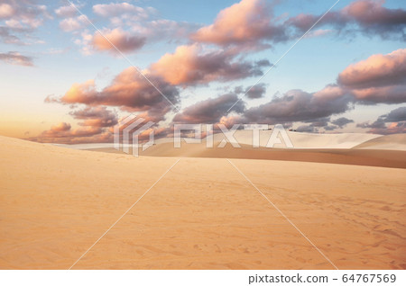 Sand dune with colorful cloud in sky on desert 64767569
