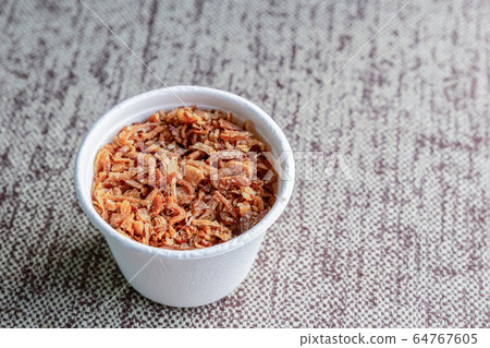 dried and caramelized garlic crushed in a white dried and caramelized garlic crushed in a white 64767605