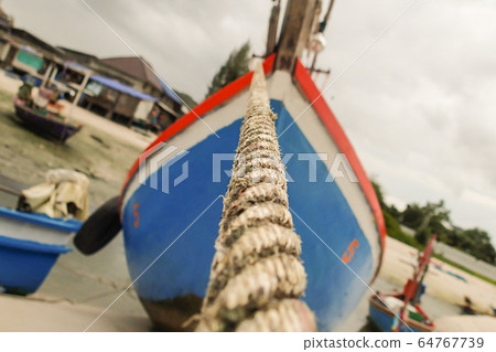 fishing boat wooden dark blue and red moored to 64767739