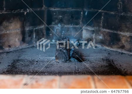 coal stands in the center of the fireplace against 64767766