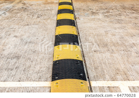 black and yellow striped road bumps installed in black and yellow striped road bumps installed in 64770028