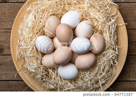Organic chicken eggs in nest closeup Organic chicken eggs in nest closeup 64771387
