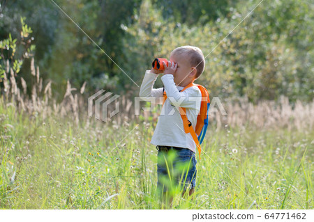 Young explorer watching with binoculars of birds 64771462