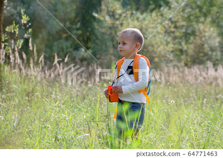 Young explorer watching with binoculars of birds 64771463