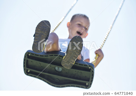 A boy swinging A boy swinging 64771840