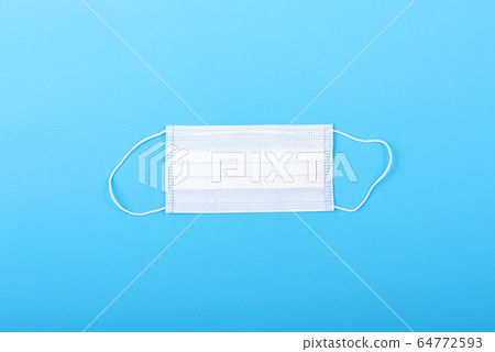 Blue background with medical surgical mask on it. Virus protection equipment. Dangerous asian ncov coronavirus. 64772593