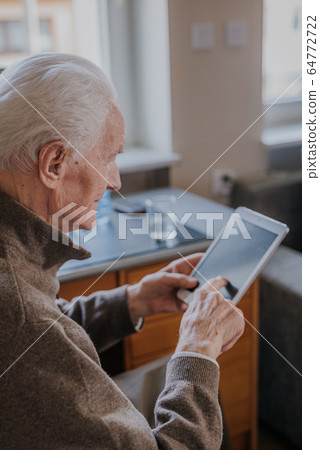 Positive Senior using Digital Tablet Positive Senior using Digital Tablet 64772722