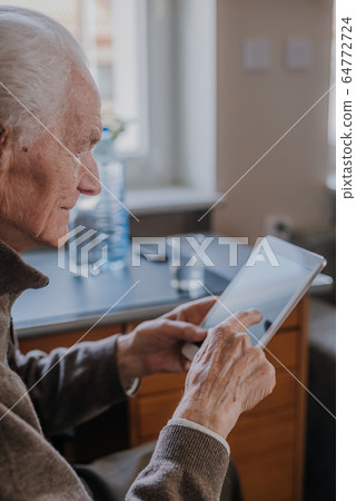 Positive Senior using Digital Tablet Positive Senior using Digital Tablet 64772724