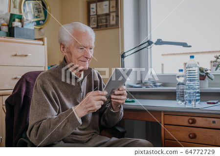 Positive Senior using Digital Tablet Positive Senior using Digital Tablet 64772729