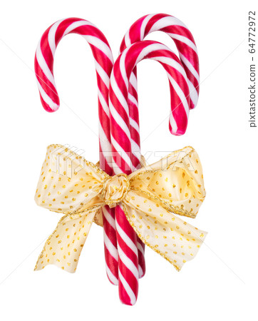 Red striped caramel sticks tied with a golden bow 64772972