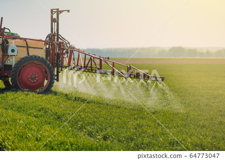 Tractor Spraying Herbicides on Field Agriculture 64773047