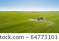 Tractor Spraying Herbicides on Field Agriculture 64773101