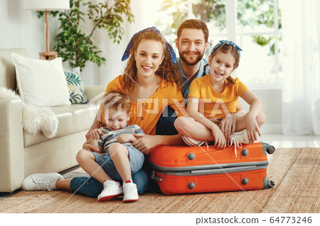Cheerful family with suitcases on floor looking at Cheerful family with suitcases on floor looking at 64773246