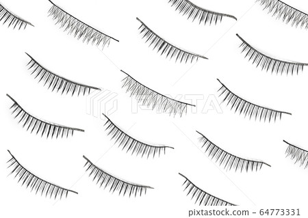 Black false eyelashes isolated on white background. Flat lay Black false eyelashes isolated on white background. Flat lay 64773331