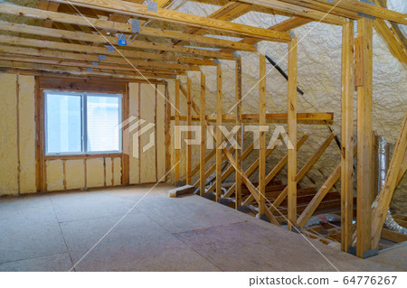 Attic with foam insulation frame house in process 64776267