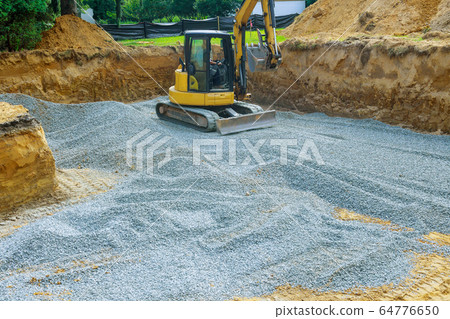 Excavator digging bucket scooping gravel from a Excavator digging bucket scooping gravel from a 64776650