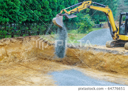 Working on a construction excavator moving gravel 64776651
