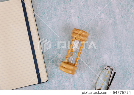 Deadline and time with hourglass and notebook of Deadline and time with hourglass and notebook of 64776754