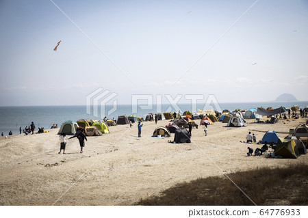A tent installed on the beach A tent installed on the beach 64776933