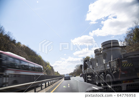 A truck carrying cargo up a hill 64776958