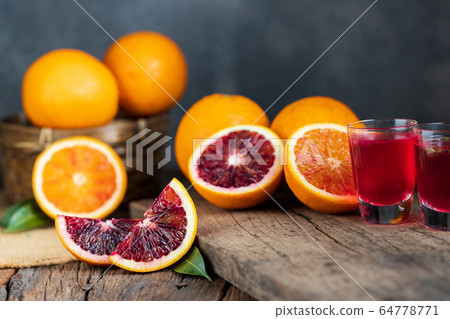 Sliced Sicilian Blood oranges fruits over old dark 64778771