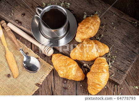 Coffee and croissants on the  wooden background, 64778793
