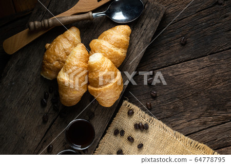 Coffee and croissants on the wooden background, 64778795