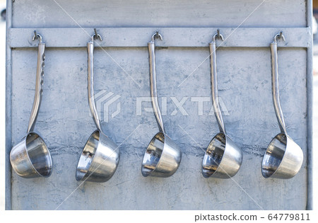 Ladle in the mineral springs Ladle in the mineral springs 64779811