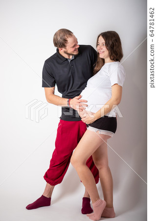 Beautiful young couple expecting baby in studio Beautiful young couple expecting baby in studio 64781462