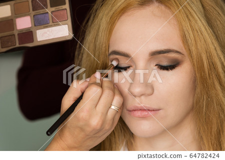 Model girl perfect applying makeup. Model girl perfect applying makeup. 64782424