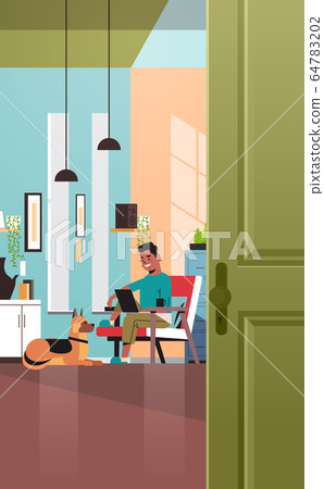 man freelancer using laptop working at home during coronavirus quarantine self-isolation freelance man freelancer using laptop working at home during coronavirus quarantine self-isolation freelance 64783202