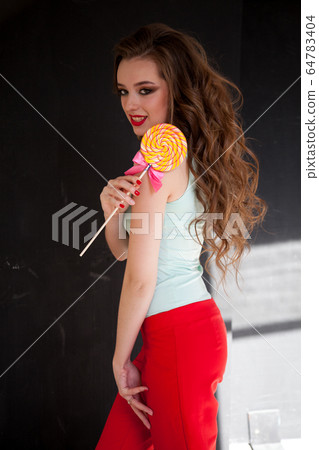 woman with long hair eats candy sweet lollipop woman with long hair eats candy sweet lollipop 64783404