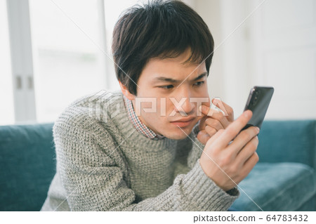 Smartphone male student Smartphone male student 64783432