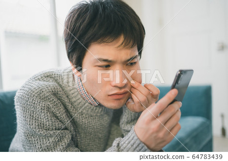 Smartphone male student Smartphone male student 64783439