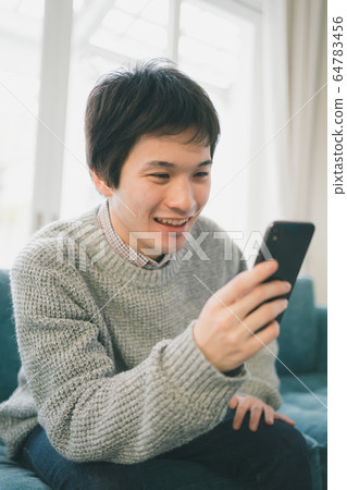 Smartphone male student Smartphone male student 64783456