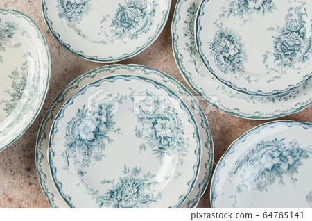 Antique porcelain plates on concrete 64785141