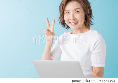 Senior woman looking at laptop computer Senior woman looking at laptop computer 64785393